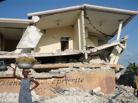 Woman standing in front of ruins.